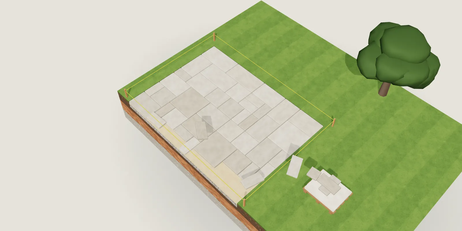 A cut-away model of a patio half laid, pavers stacked on a pallet beside it